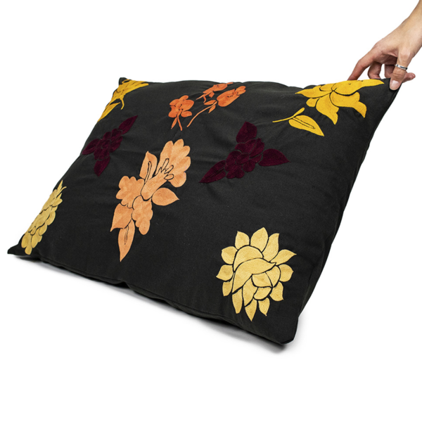 Handmade Cushion Cover with orange embroidered details.